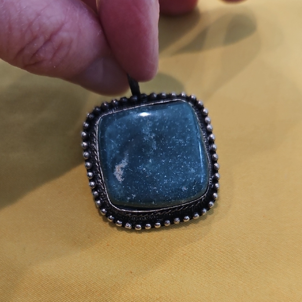 Vintage handmade silver or silver like pendant featuring square-cut green stone
